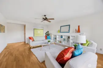 The far end of the spacious living room leads back to the sleeping wing, kitchen and features a view window and glass door to the large, courtyard. A handsome custom book case stands where once was a fireplace.