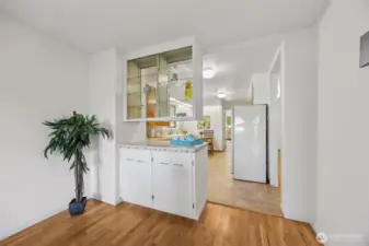 A close-up of the built in, pass through dish and display cabinet, shows just one example of the mid-century design elements and the thoughtful built-in storage found throughout the home.