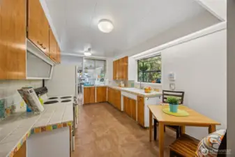 Many cabinets options and built-in wall storage offer loads of room for all your kitchen gear including an opaque spice shelf with sliding doors above the range.