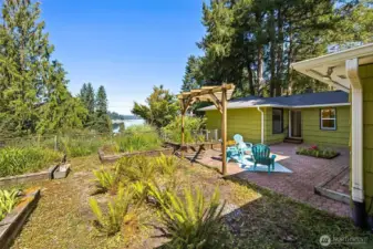 Enjoy the partial views of Eld Inlet and sunsets from the large garden area.  The small tree in the center could be, cherished as it is, or removed to open up more view.