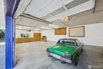 The interior of the shop shows two bay with garage doors for parking and a third bay with work space, cabinets and room for workbenches, tools, bikes, motorcycles and recreational equipment. Hard to find!