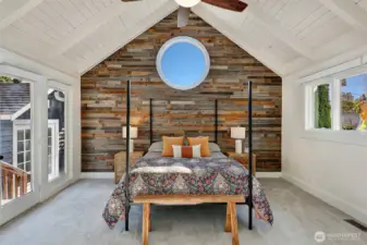 The primary retreat offers large closet spaces, vaulted ceiling, and custom accent wall.