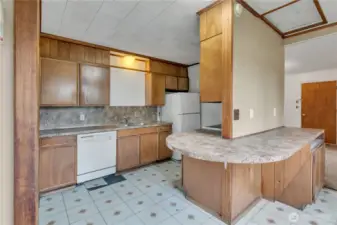 Large kitchen with ample counter space for meal preparation.