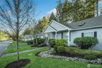 These duplex-style condos are situated along a quiet, tree-lined street, creating an idyllic atmosphere.