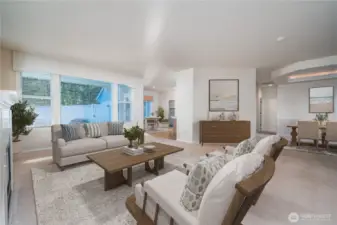 A perspective highlighting how the living room flows effortlessly into the dining room and kitchen. Virtually Staged.