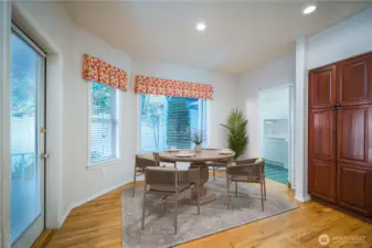 The living room opens to the casual kitchen eating nook, with large windows overlooking the enclosed back patio.