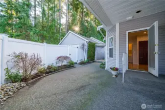 There’s even space for gardening if you desire. Notice the convenient gate that leads to the driveway behind the condo.