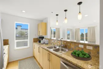The kitchen blends style and functionality with granite countertops and sleek stainless steel appliances.