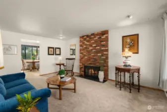 Inviting living room with wood burning fireplace.