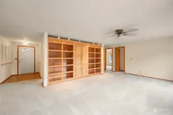 The family room is enhanced by a ceiling fan and built-in book shelves