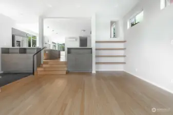 In the living room looking toward open kitchen and dining.