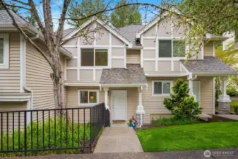 Welcome home to this two-story townhome-style condo. (Note: grass greener than it appears in person due to the magic of photo editing!)