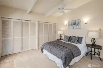 Primary Bedroom with ensuite bathroom, a wall of closet space, and a private hot tub just outside on the patio.