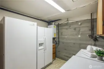 Large downstairs utility room with...plenty of room for that extra fridge and freezer.  notice the tankless water heater.   There is a nice wash tub too.