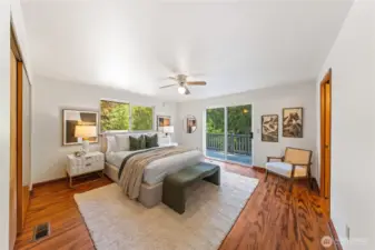 Primary suite with ceiling fan comfort and private deck overlooking the fenced backyard—wake up to the sound of birds and your own peaceful retreat.