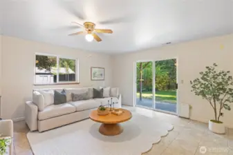 Lower-level family room with sliding glass doors leading to the backyard and hot tub—perfect for indoor-outdoor living.