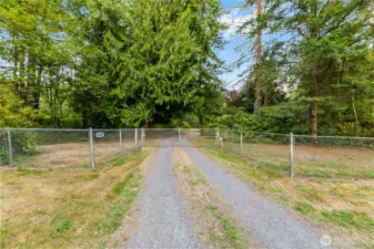 Fenced entry with gated driveway provides added privacy and security as you enter this peaceful 5-acre Arlington retreat.