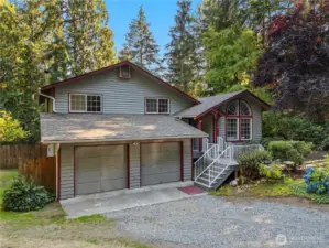 Arlington home with fresh exterior paint, charming architectural details, and a two-car garage. Surrounded by mature trees and landscaping, this property offers privacy and curb appeal on 5 peaceful acres.