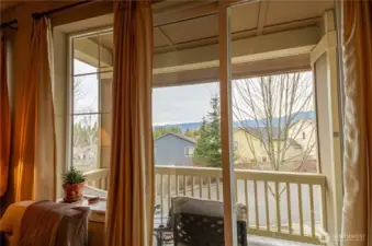 A Mountain View balcony just off the living area....covered to protect you from elements and perfectly situated for viewing the majestic Cascade mountain range. It's  a place where you can sit with a morning cup of coffee and be rewarded with a beautiful sunrise or enjoy a lazy summer afternoon relaxing with a refreshing beverage. There is room for ample seating, a little table, an outdoor rug and plenty of potted plants to make the space comfortable and welcoming.