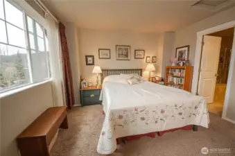 The primary bedroom includes a luxurious ensuite full bath, the door that leads to it is pictured to the right.