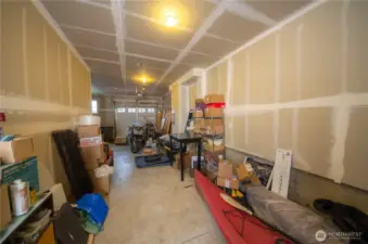 The tandem garage can comfortably fit a couple of cars with additional room on the far left for a fridge, freezer, gardening supplies and more.