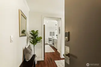 welcoming entry to the corner unit at the top floor.