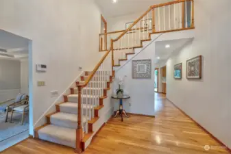 Staircase open to entry. Hardwood floors through entry, kitchen, & dining room.