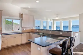 Kitchen boasts solid surface counters, SS appliances, and bar seating!