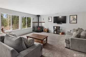 Open concept living room with a wood stove to keep you warm and cozy all winter long.