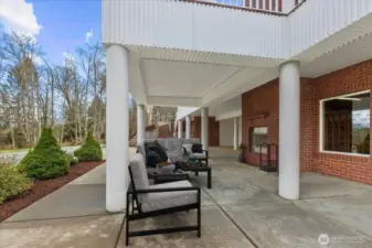 Virtually staged. Lower level covered patio featuring an outdoor fireplace.
