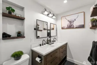 The primary en suite offers a beautifully updated 3/4 bath, showcasing a sleek and modern design.