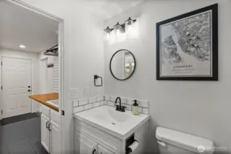 Beyond the laundry room, discover a freshly updated full bath.