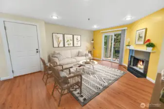 Another view of the living room, modern  fireplace and mantle, and can lighting. The  patio doors lead to your own private deck  overlooking a beautiful wooded greenbelt!