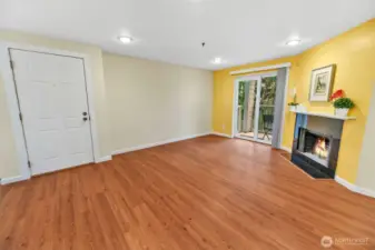 Here is another photo (same view as the  previous virtually staged view). This wood  burning fireplace and room are virtually  staged.