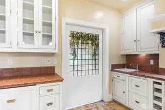 Kitchen is the heart of the home; accessed direction from the entrance, or from the formal dining or towards the informal living. Towards the other direction is the sunroom; a gorgeous space surrounded by leaded glass doors sourced from a French hotel.