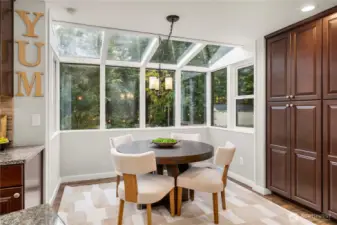 Enjoy your meals in this bright dining nook with views of the lush back yard