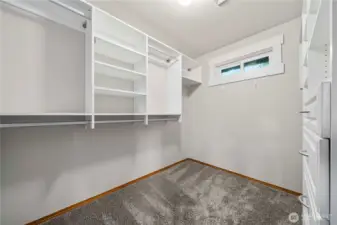 Primary walk-in closet with custom shelving