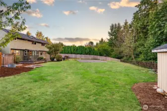 The large, fenced back yard offers plenty of room for gardening, recreation, or enjoying nature. It's appointed with blueberry bushes and fruit trees