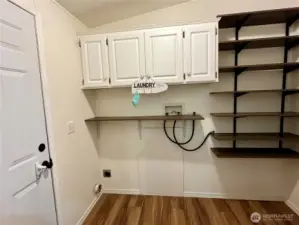 Laundry room with shelves and washer/dryer hookup