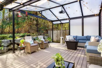 Enjoy year-round outdoor living on the spacious back deck featuring low-maintenance composite decking and a translucent covered roof that filters natural light while keeping the elements out. The deck overlooks 16 acres of Greenbelt, offering peaceful privacy, greenery, and wildlife views with no neighbors behind you.