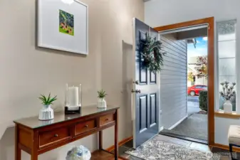 Inviting front entry with tile floor leads to solid hardwood flooring on main level as well as upstairs.