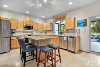 Updated kitchen with solid surface stone counters, tile backsplash, undercabinet lighting, gas range. Serene views from kitchen, dining, living.