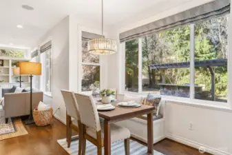 Sunny eating nook opening to a gated deck with built-in seating and draperies