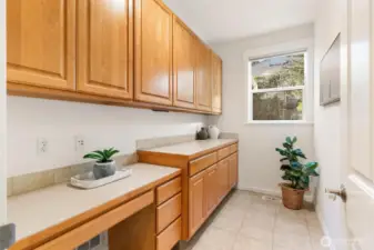 Mud room with built in desk area and storage cabinets.