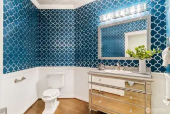 Spacious 1/2 bathroom with custom built in sink.