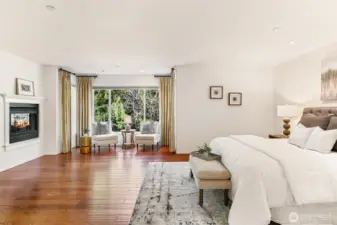 Massive master retreat featuring hardwood floors, a private 2 way fireplace, and a dedicated sitting area