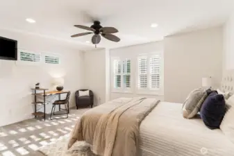 4th bedroom with built-in tv and closet with shelving, large windows