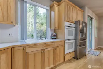Bright kitchen window overlooks the serene back yard