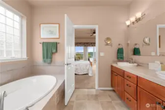 The primary bathroom has a large soaking tub and separate shower.
