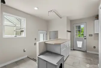 Laundry area with access to backyard.